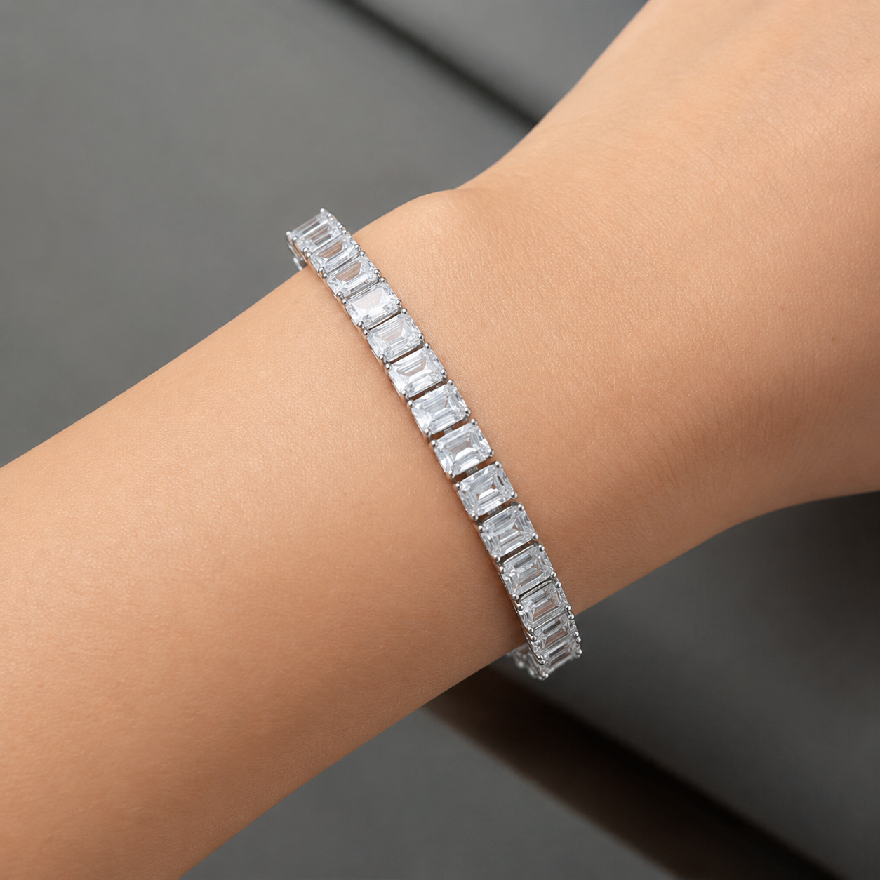 Emerald-cut diamond tennis bracelet worn on the wrist